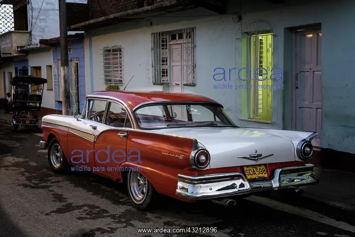 : 1950's era Ford Fairlane and colorful buildings : 1950's era Ford Fairlane and colorful buildings