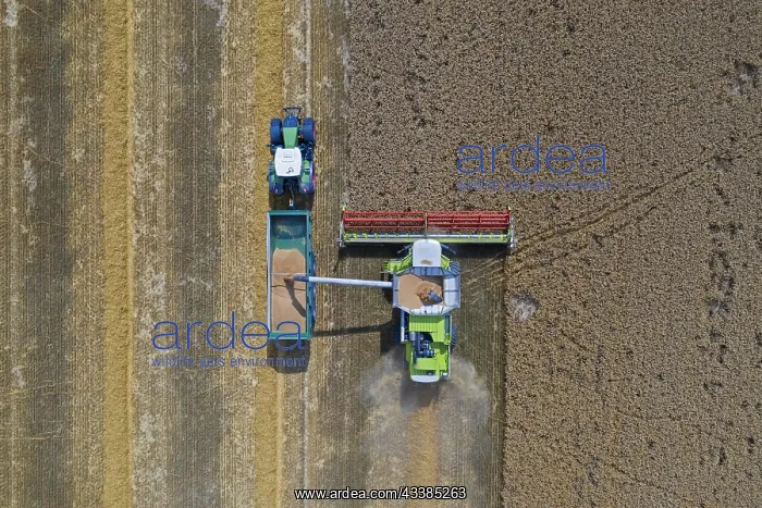 : Aerial view of combine harvester and tractor with : Aerial view of combine harvester and tractor with