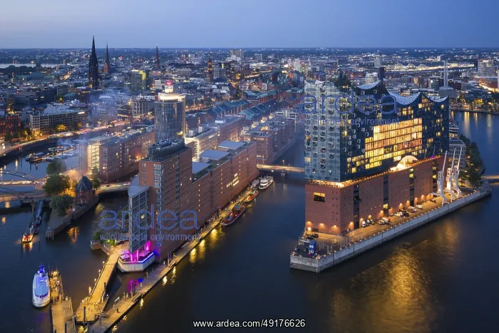 : Aerial view of the Elbphilharmonie at blue hour with illuminated windows and view over the Speicherstadt and Hafencity : Aerial view of the Elbphilharmonie at blue hour with illuminated windows and view over the Speicherstadt and Hafencity