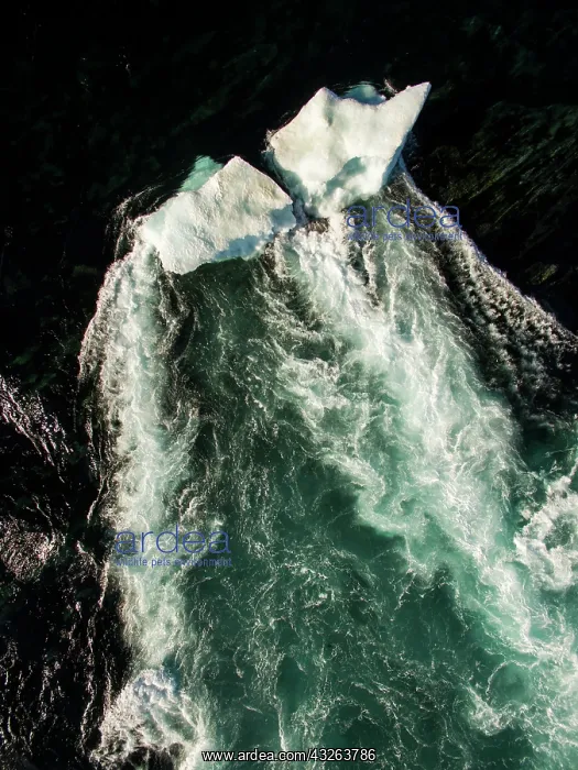 : Aerial view of iceberg grounded in shallow rapids : Aerial view of iceberg grounded in shallow rapids