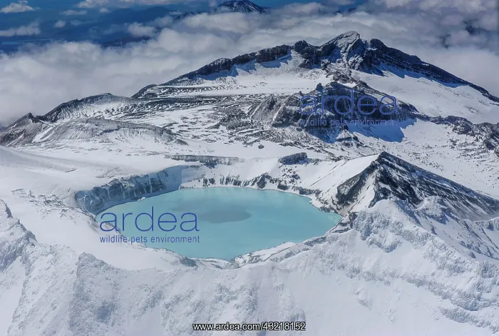 : Aerial view of a tuquoise crater lake on top of : Aerial view of a tuquoise crater lake on top of