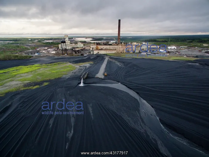 : Aerial view of vast field of black slag surrounding : Aerial view of vast field of black slag surrounding