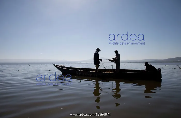  : African Fishermen - silhouettes - with nets in dugout canoe