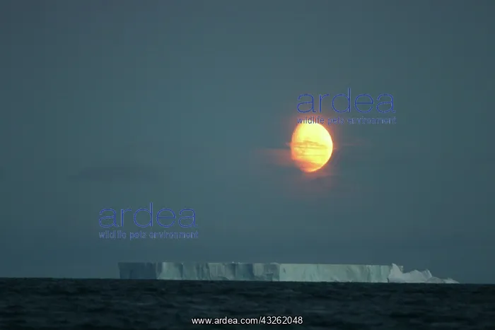 : Antarctica, Gibbous moon rises above massive : Antarctica, Gibbous moon rises above massive