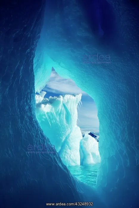 : Antarctica, Iceberg framed in arch of another : Antarctica, Iceberg framed in arch of another