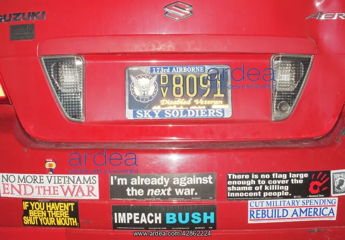 : Anti-war slogans - on rear of a car as it was seen : Anti-war slogans - on rear of a car as it was seen