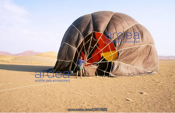 : Balloon Safari - after landing, the pilot assists : Balloon Safari - after landing, the pilot assists
