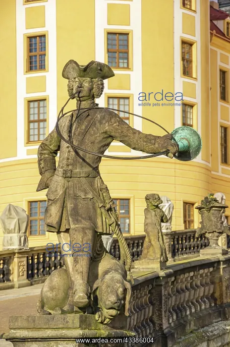 : Baroque statue of a hunter with dog in front of : Baroque statue of a hunter with dog in front of