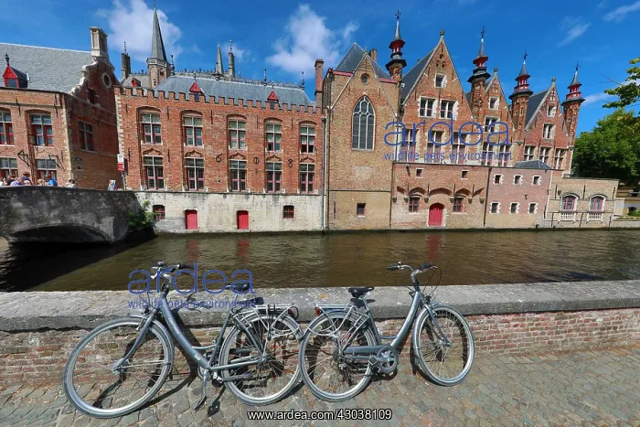 : Bicycles leaning against a canal wall with medievel : Bicycles leaning against a canal wall with medievel