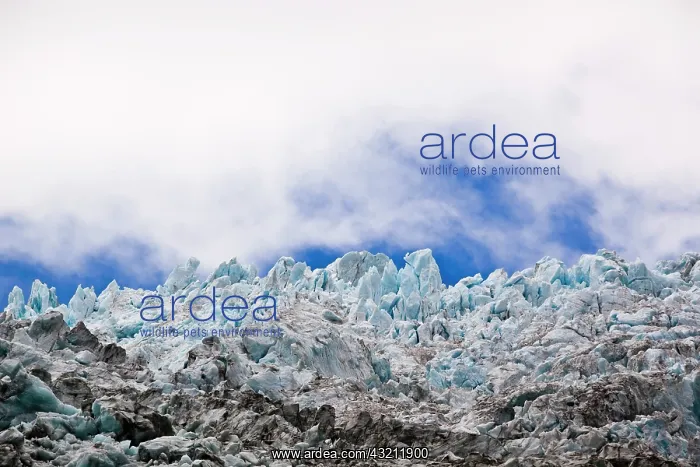 : Blue glacial ice against sky and clouds : Blue glacial ice against sky and clouds