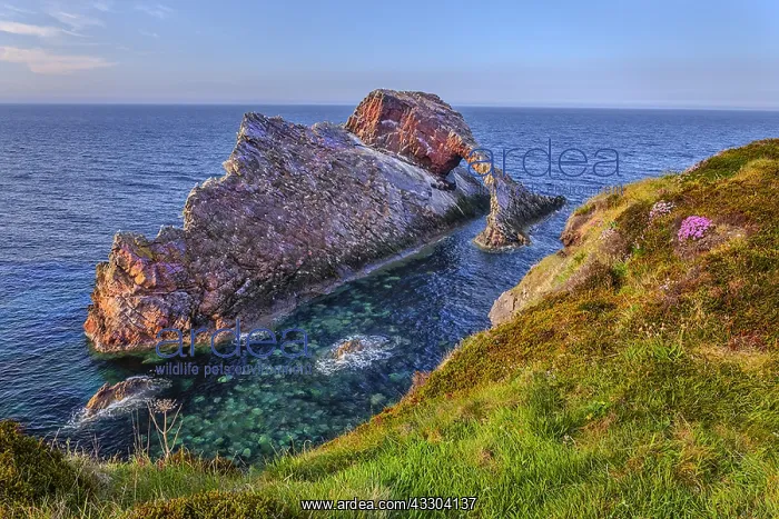 : Bow Fiddle Rock - natural sea arch and steep with : Bow Fiddle Rock - natural sea arch and steep with