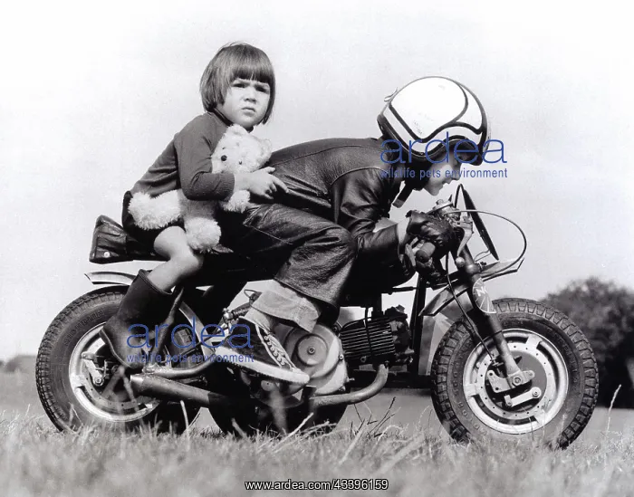 : Boy and girl riding a motorcycle, England, Great B : Boy and girl riding a motorcycle, England, Great B