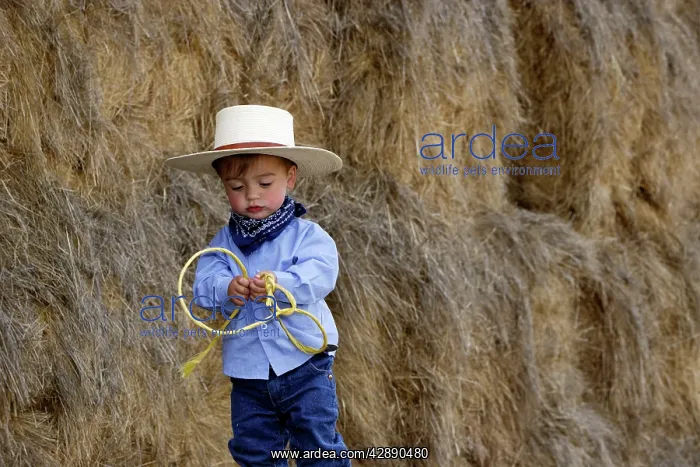 : Boy playing at being a cowboy : Boy playing at being a cowboy