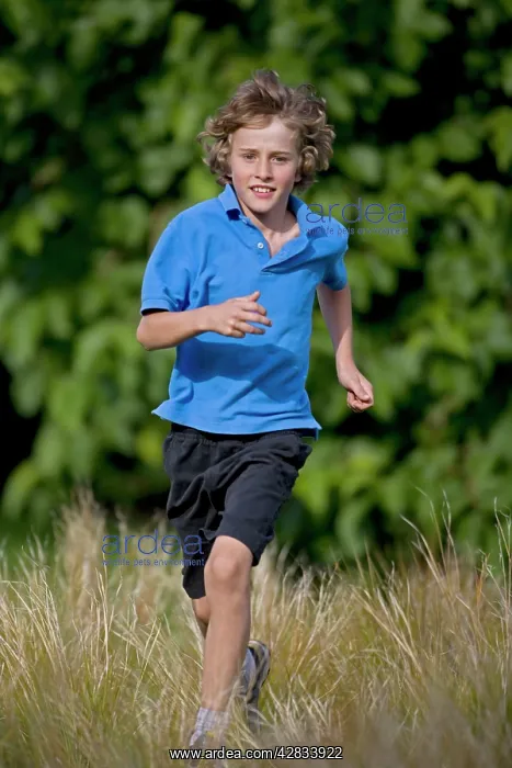 : Boy Running in Field - Age 10 : Boy Running in Field - Age 10