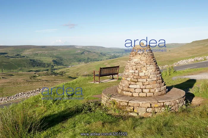 : Cairn and bench at highland viewpoint overlooking : Cairn and bench at highland viewpoint overlooking