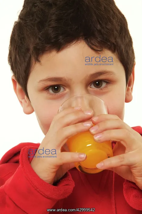  : Child boy drinking orange juice