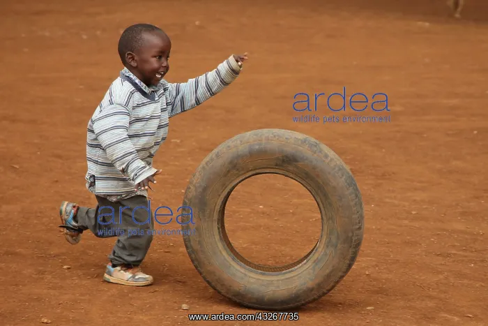 : Child playing with tire, near Eldoret, Kenya, Kalenjin : Child playing with tire, near Eldoret, Kenya, Kalenjin