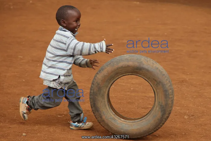 : Child playing with tire, near Eldoret, Kenya, Kalingen : Child playing with tire, near Eldoret, Kenya, Kalingen
