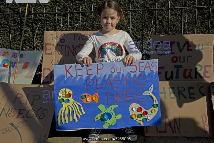 : Child on student climate change strike holding a : Child on student climate change strike holding a