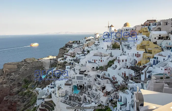 : Cliff-side houses, villas and windmill in the vi : Cliff-side houses, villas and windmill in the vi