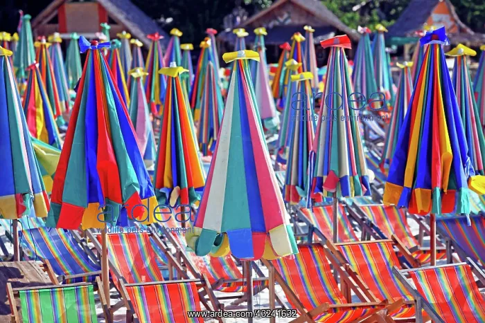 : Colourful beach umbrellas and deckchairs for a summer ho : Colourful beach umbrellas and deckchairs for a summer ho