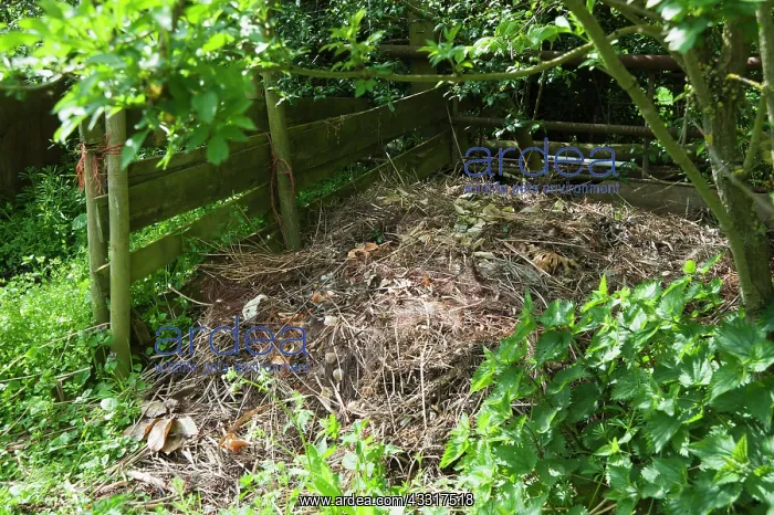 : A compost heap made with wooden planks and posts : A compost heap made with wooden planks and posts