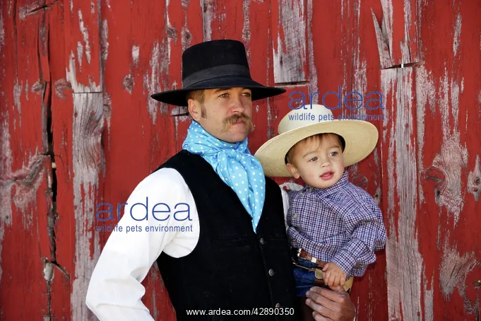 : Cowboy carrying child : Cowboy carrying child