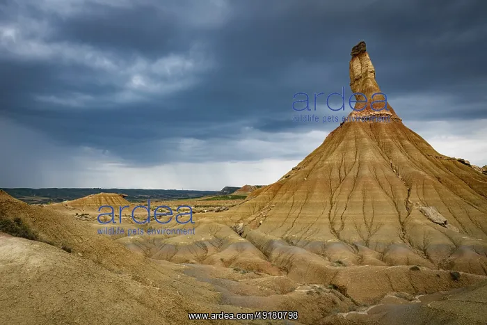 : Dark clouds and rain as background of the Castildeterra rock formation in the Bardenas Blanca area of the Bardenas : Dark clouds and rain as background of the Castildeterra rock formation in the Bardenas Blanca area of the Bardenas