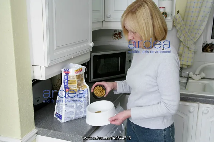 : Dog Owner - Measuring out dried / dry food for : Dog Owner - Measuring out dried / dry food for