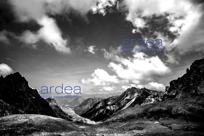  : Dramatic black and white image of a rocky mountain landscape under a cloudy sky