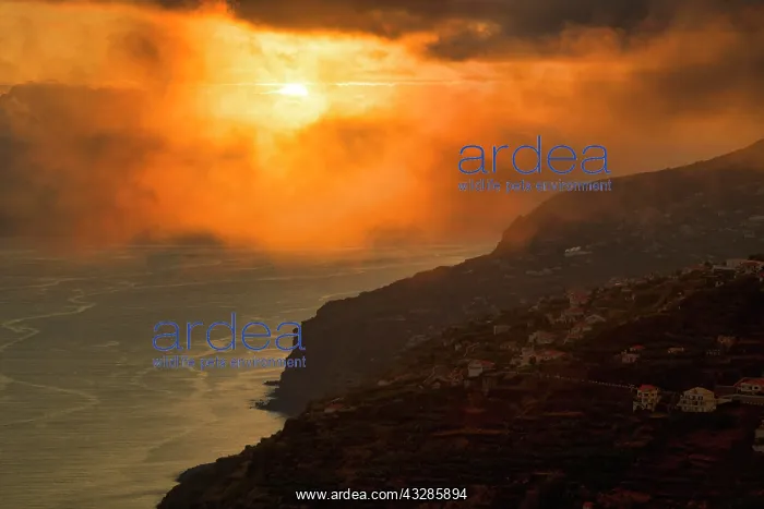 : Dramatic cloudy sky at sunset, steep coast near : Dramatic cloudy sky at sunset, steep coast near