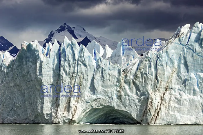 : Dramatic glacier with threatening clouds and mountains in the background : Dramatic glacier with threatening clouds and mountains in the background