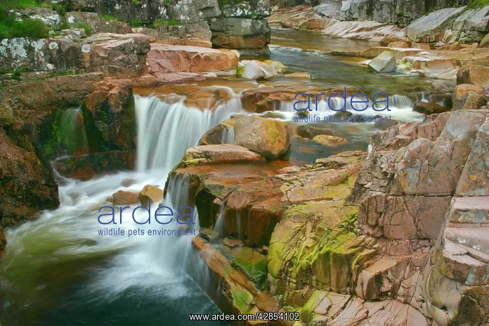 : Etive river cascades - water flowing over red rocks : Etive river cascades - water flowing over red rocks