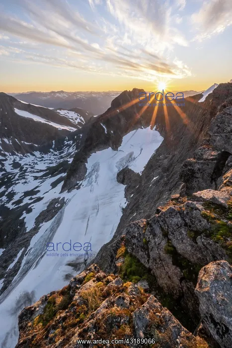 : Evening atmosphere, sun shining over mountains in : Evening atmosphere, sun shining over mountains in