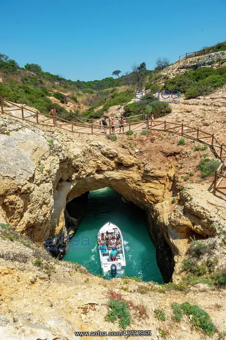 : Excursion boat in the turquoise sea passes through : Excursion boat in the turquoise sea passes through