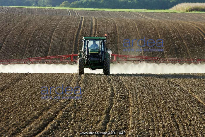 : Farming - farmer spraying crops in tractor : Farming - farmer spraying crops in tractor