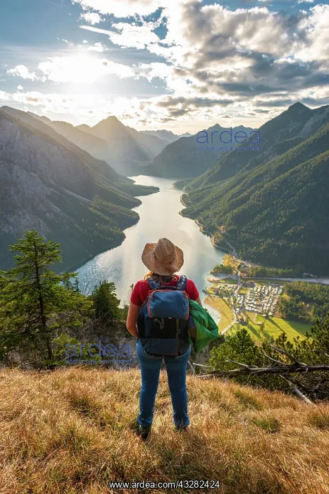 : Female hiker with a sun hat looking into the distance : Female hiker with a sun hat looking into the distance