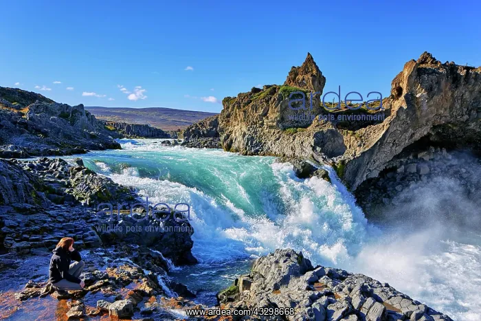 : Female tourist at waterfall Godafoss, Laugar, Fossh&, xecb29; : Female tourist at waterfall Godafoss, Laugar, Fossh&, xecb29;