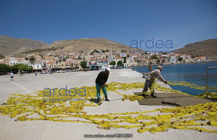 : Fishermen drying their nets on the island of Halki : Fishermen drying their nets on the island of Halki