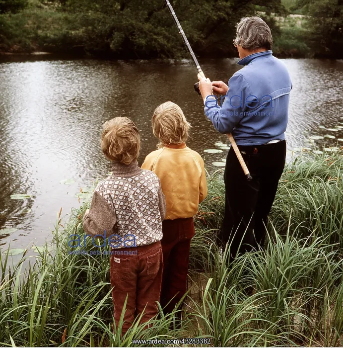 : FISHING - Man with children by river : FISHING - Man with children by river