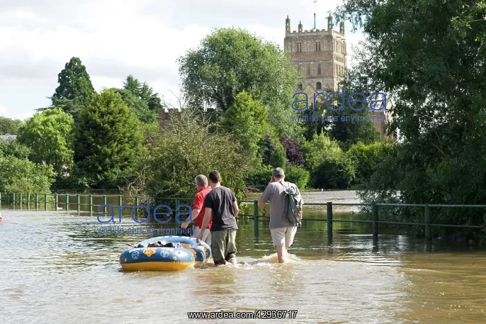 : Flooding - People with rubber dingy carrying bottled : Flooding - People with rubber dingy carrying bottled