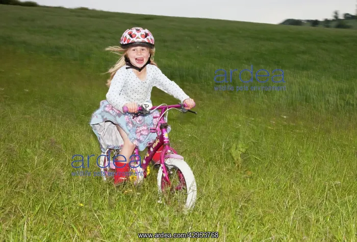 : Girl enjoying cycling fast on farm field : Girl enjoying cycling fast on farm field
