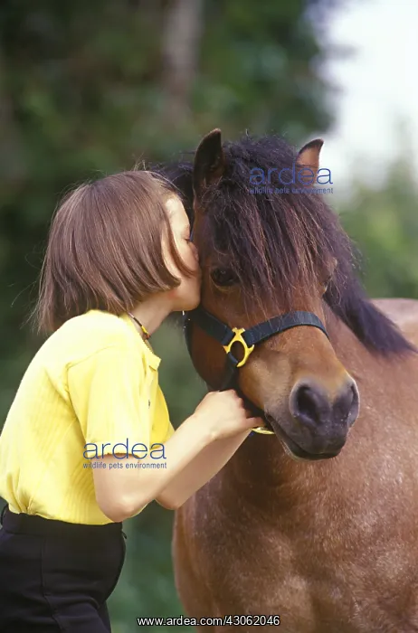 : Girl kissing her pony : Girl kissing her pony