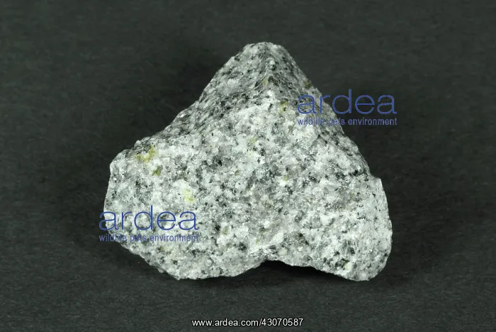 : Granite. Hand sample of Granite, a crystalline intrusive igneous rock consisting : Granite. Hand sample of Granite, a crystalline intrusive igneous rock consisting