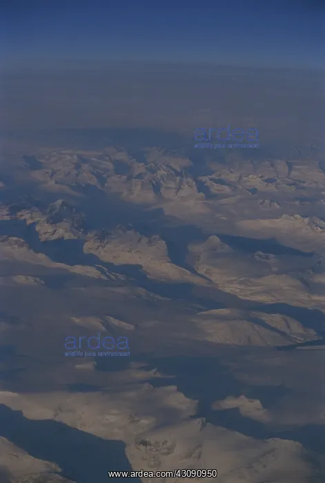 : Greenland. Barren glaciers stretch to the horizon in this aerial view of Greenland : Greenland. Barren glaciers stretch to the horizon in this aerial view of Greenland