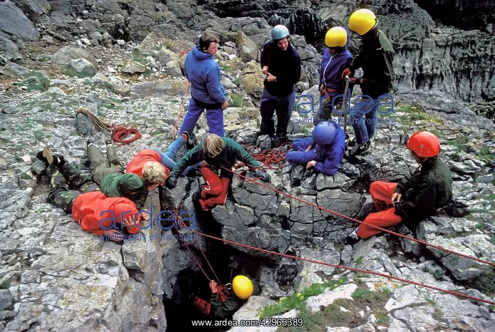 : Group of young people caving : Group of young people caving