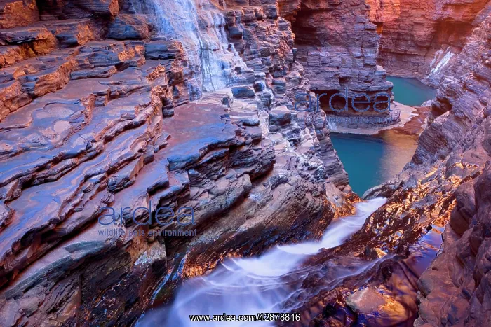 : Hancock Gorge - water is flowing down a waterfall : Hancock Gorge - water is flowing down a waterfall