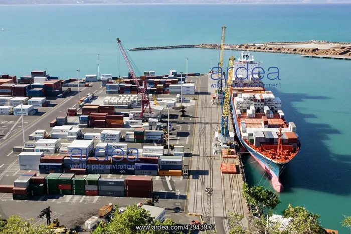 : Harbour - containers stacked on quayside and container : Harbour - containers stacked on quayside and container