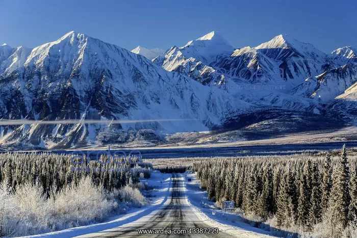 : Highway in winter landscape in front of snow-covered : Highway in winter landscape in front of snow-covered