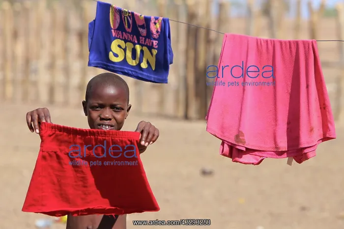 : Himba girl helps her mom do the laundry : Himba girl helps her mom do the laundry